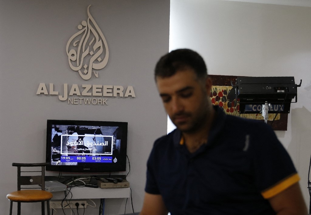 Employees of Qatar based news network and TV channel Al-Jazeera are seen at their Jerusalem office on July 31, 2017